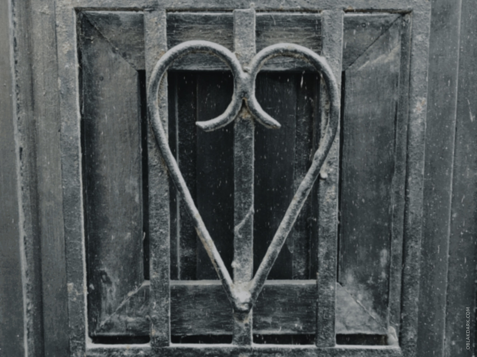 A metal frame on a door with the shape of a heart. Dark Photography and Poetry by Nathalie Markoch | OBLAK